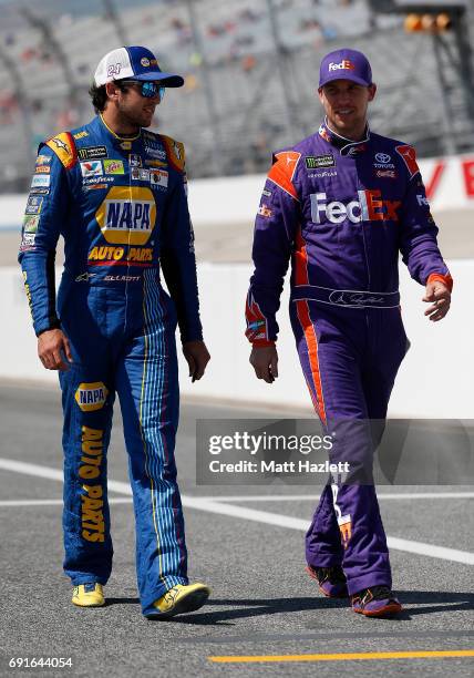Chase Elliott , driver of the NAPA Chevrolet, speaks with Denny Hamlin, driver of the FedEx Express Toyota, on the grid during qualifying for the...