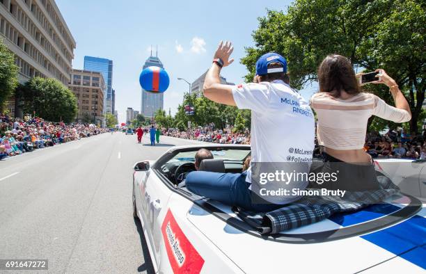 101st Indianapolis 500 Preview: Rear view of Fernando Alonso with girlfriend Linda Morselli seated on car during parade before practice session at...