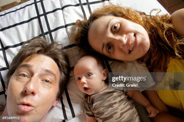 father, mother and newborn daughter in a selfie. - tired mother stock pictures, royalty-free photos & images