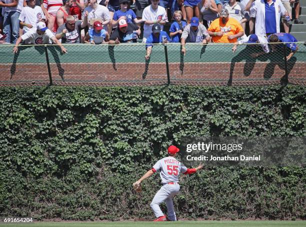 Fans harass Stephen Piscotty of the St. Louis Cardinals as he misplays the ball on a double by Jason Heyward of the Chicago Cubs in the 6th inning at...