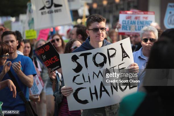 Demonstrators protest President Donald Trump's decision to exit the Paris climate change accord on June 2, 2017 in Chicago, Illinois. Yesterday, in a...