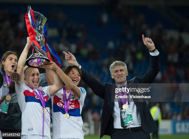 Pauline Bremer, Saki Kumagai and Coach Gerard Precheur celebrate victory in the UEFA Women's Champions League Final between Olympique Lyonnais and...