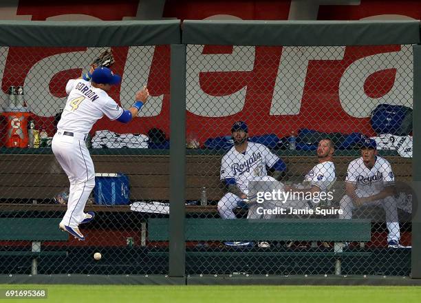 Alex Gordon of the Kansas City Royals misses a fly ball up against the left field fence off the bat of Yan Gomes of the Cleveland Indians during the...