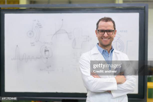 portrait of a happy engineering teacher at the university - science teacher stock pictures, royalty-free photos & images