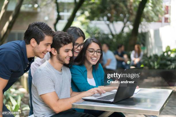 group of students at the university using a laptop computer - university student stock pictures, royalty-free photos & images