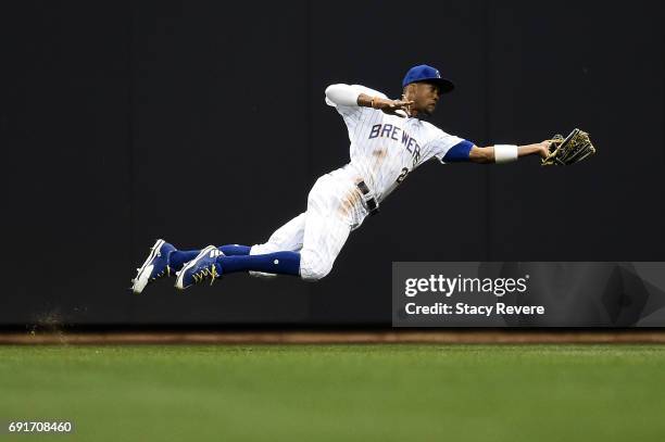 Keon Broxton of the Milwaukee Brewers dives for fly ball during the tenth inning of a game against the Los Angeles Dodgers at Miller Park on June 2,...