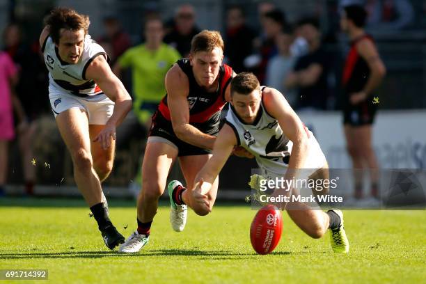 Brenton Payne of North Ballarat Roosters and Josh Begley of Essendon Bombers fight for the ball during the round seven VFL match between Essendon and...