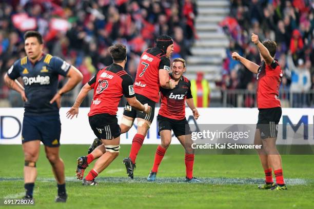 Mitchell Hunt of the Crusaders is congratulated by team mates after kicking the last minute winner during the round 15 Super Rugby match between the...