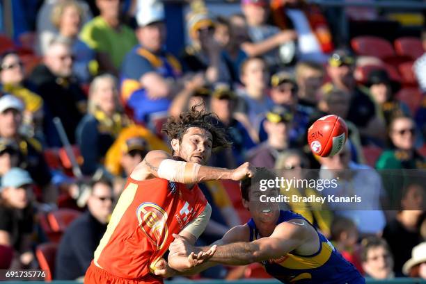 Suns player Jarrod Harbrow gets a handball away during the round 11 AFL match between the Gold Coast Suns and the West Coast Eagles at Metricon...