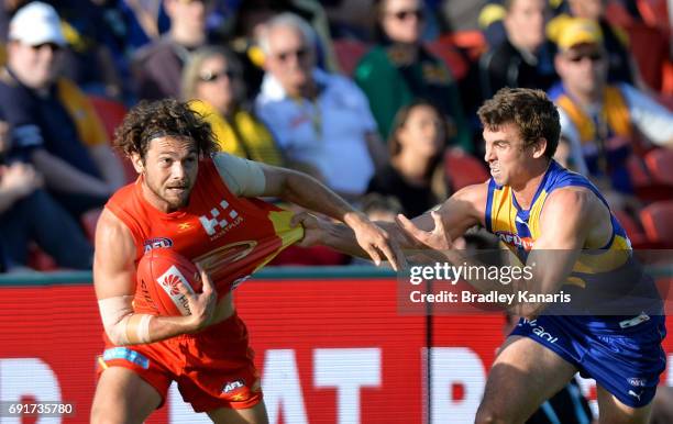 Suns player Jarrod Harbrow attempts to break away from the defence during the round 11 AFL match between the Gold Coast Suns and the West Coast...