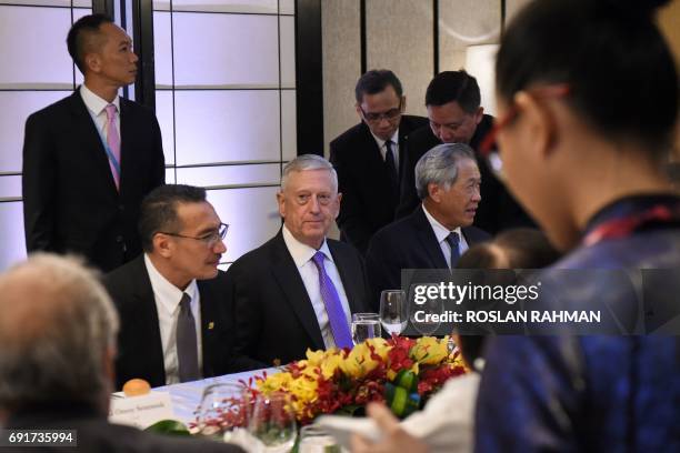 Pentagon chief Jim Mattis sits with Malaysia's Defence Minister Hishammuddin Tun Hussein and Singapore's Defence Minister Ng Eng Hen during a...