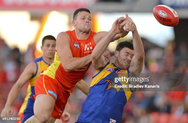 Suns player Steven May and West Coast Eagles player Jeremy McGovern challenge for the ball during the round 11 AFL match between the Gold Coast Suns...