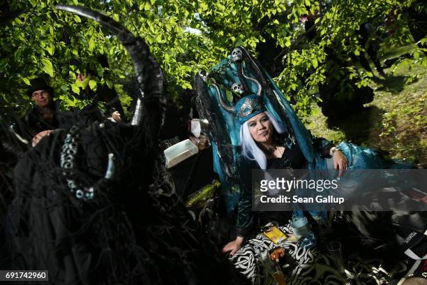 Visitors with horned headgear relax at their picnic blanket as they attend the Victorian Picnic on the first day of the annual Wave-Gotik-Treffen...
