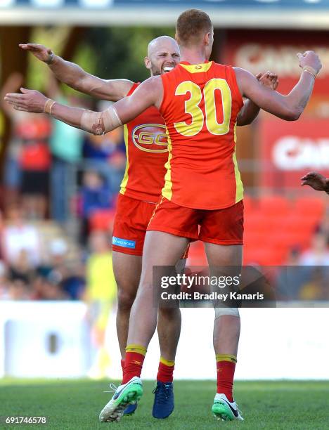 Suns player Peter Wright celebrates with team mate Gary Ablett after kicking the winning goal during the round 11 AFL match between the Gold Coast...