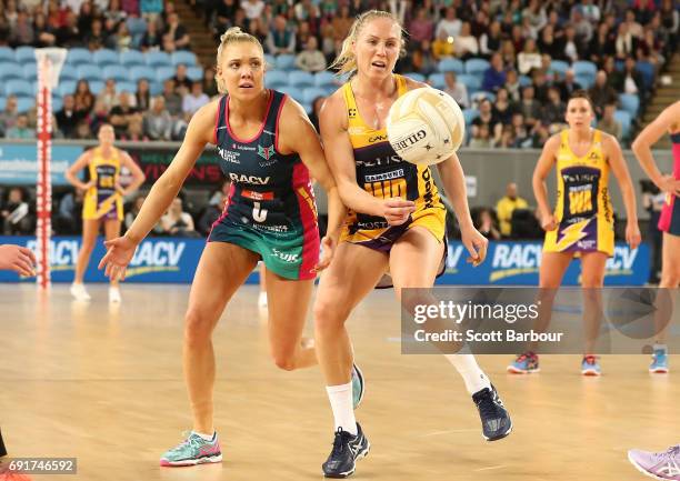 Laura Langman of the Lightning and Elizabeth Watson of the Vixens compete for the ball during the Super Netball Major Semi Final match between the...