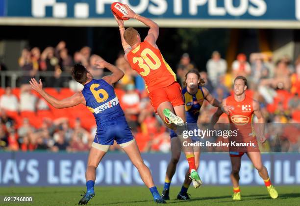 Suns player Peter Wright takes a mark before going on to kick the winning goal during the round 11 AFL match between the Gold Coast Suns and the West...