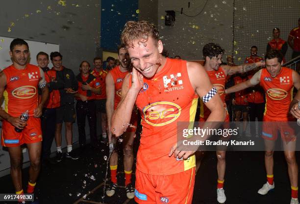 Suns player Will Brodie is sprayed with gatorade as he celebrates victory during the round 11 AFL match between the Gold Coast Suns and the West...