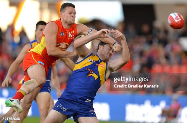 Suns player Steven May and West Coast Eagles player Jeremy McGovern compete for the ball during the round 11 AFL match between the Gold Coast Suns...