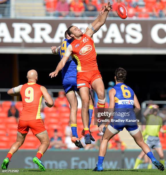 Suns player Jarrod Witts and West Coast Eagles player Nathan Vardy compete for the ball during the round 11 AFL match between the Gold Coast Suns and...