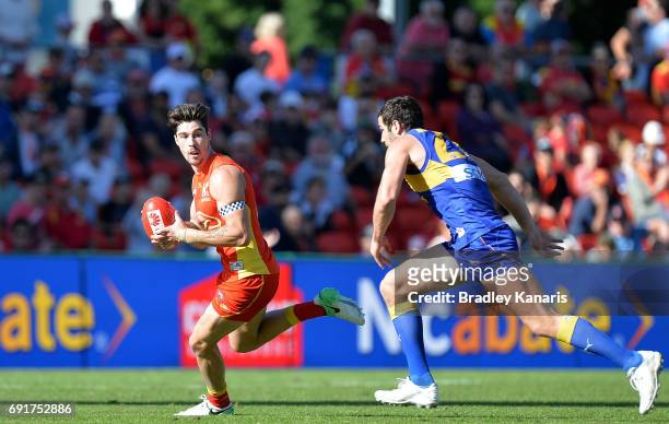 Suns player Alex Sexton breaks away from the defence during the round 11 AFL match between the Gold Coast Suns and the West Coast Eagles at Metricon...