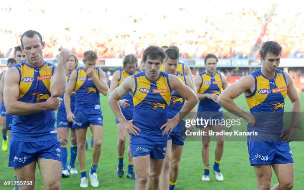 West Coast players look dejected after losing the round 11 AFL match between the Gold Coast Suns and the West Coast Eagles at Metricon Stadium on...