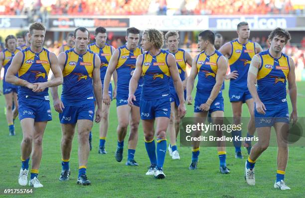 West Coast players look dejected after losing the round 11 AFL match between the Gold Coast Suns and the West Coast Eagles at Metricon Stadium on...