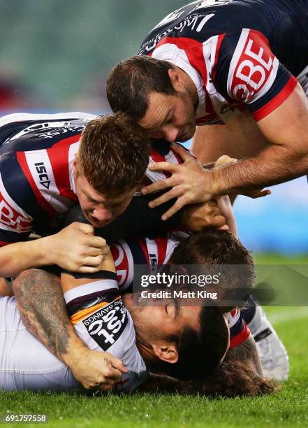 Adam Blair of the Broncos is tackled during the round 13 NRL match between the Sydney Roosters and the Brisbane Broncos at Allianz Stadium on June 3,...