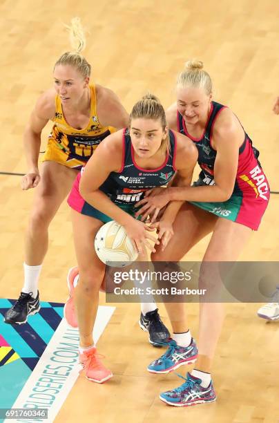 Laura Langman of the Lightning and Elizabeth Watson and Joanna Weston of the Vixens compete for the ball during the Super Netball Major Semi Final...