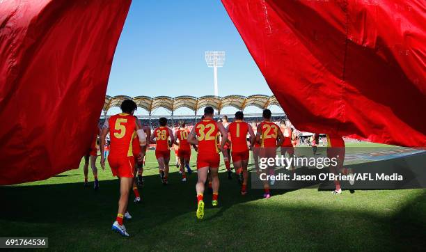 Suns players take the field during the round 11 AFL match between the Gold Coast Suns and the West Coast Eagles at Metricon Stadium on June 3, 2017...