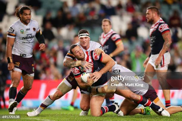 Boyd Cordner of the Roosters is tackled during the round 13 NRL match between the Sydney Roosters and the Brisbane Broncos at Allianz Stadium on June...
