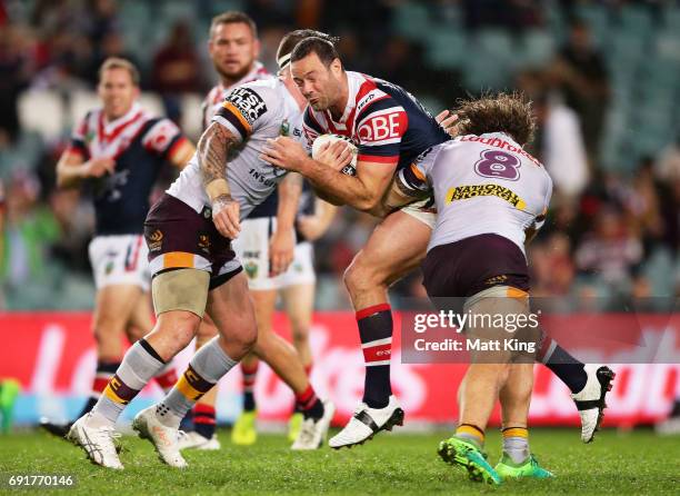 Boyd Cordner of the Roosters is tackled during the round 13 NRL match between the Sydney Roosters and the Brisbane Broncos at Allianz Stadium on June...