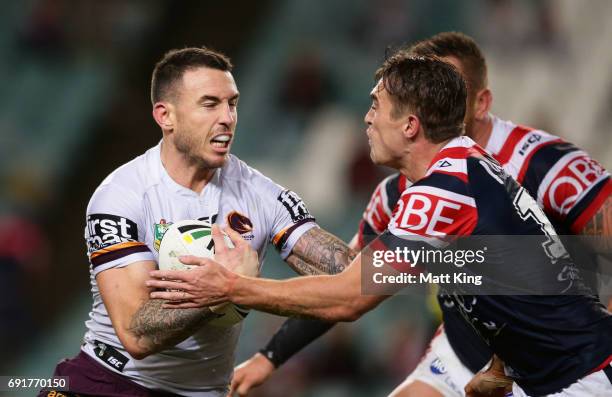 Darius Boyd of the Broncos is tackled during the round 13 NRL match between the Sydney Roosters and the Brisbane Broncos at Allianz Stadium on June...