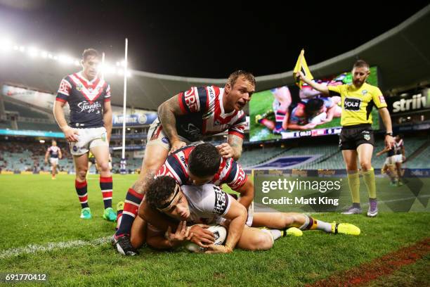 James Roberts of the Broncos is tackled over the sideline during the round 13 NRL match between the Sydney Roosters and the Brisbane Broncos at...