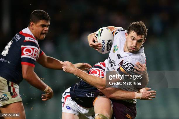 Corey Oates of the Broncos is tackled during the round 13 NRL match between the Sydney Roosters and the Brisbane Broncos at Allianz Stadium on June...