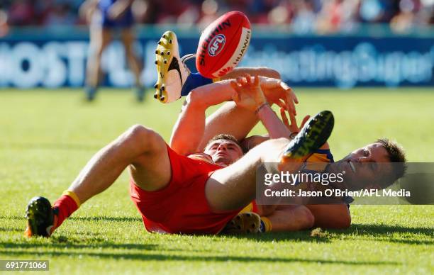 Sam Mitchell of the Eagles tackles Pearce Hanley of the Suns during the round 11 AFL match between the Gold Coast Suns and the West Coast Eagles at...