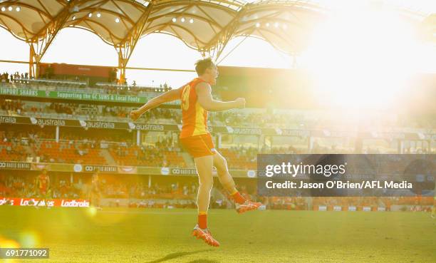 Tom Lynch of the Suns celebrates on the final whistle during the round 11 AFL match between the Gold Coast Suns and the West Coast Eagles at Metricon...