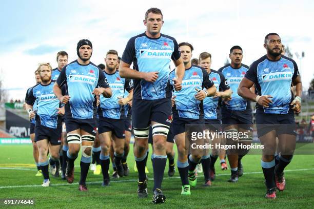 Dean Mumm of the Waratahs leads players off the field after warming up during the round 15 Super Rugby match between the Chiefs and the Waratahs at...
