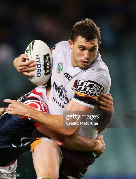 Corey Oates of the Broncos is tackled during the round 13 NRL match between the Sydney Roosters and the Brisbane Broncos at Allianz Stadium on June...