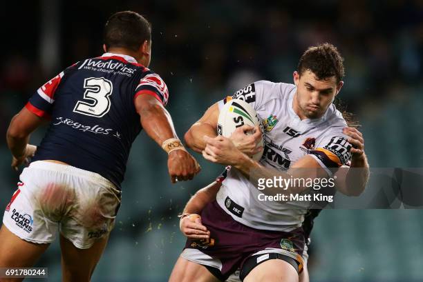 Corey Oates of the Broncos is tackled during the round 13 NRL match between the Sydney Roosters and the Brisbane Broncos at Allianz Stadium on June...