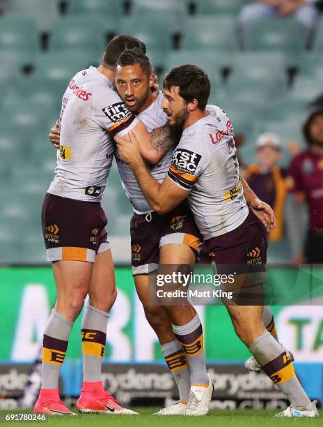 Benji Marshall of the Broncos celebrates with team mates after scoring a try during the round 13 NRL match between the Sydney Roosters and the...