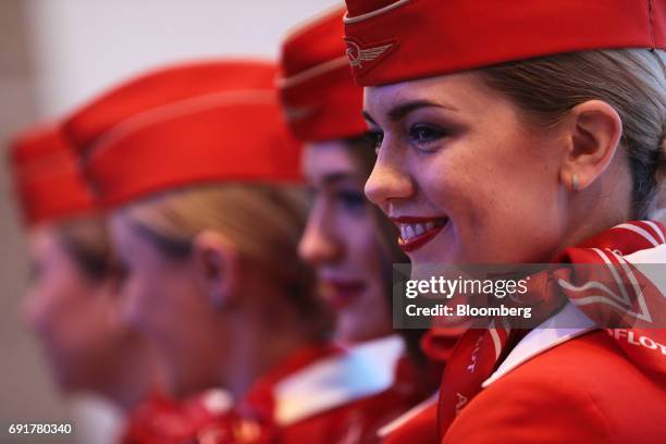 Airline staff from Aeroflot-Russian Airlines PJSC, pose for photographs during the St. Petersburg International Economic Forum at the Expoforum in...