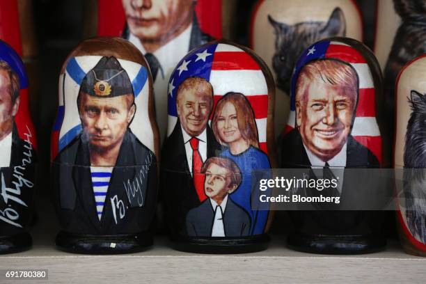 Souvenir matryoshka dolls depicting Vladimir Putin, Russia's president, left, and Donald Trump, US president, and his family sit on display at a...