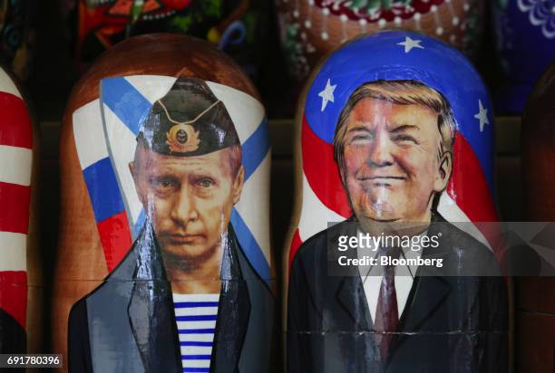 Souvenir matryoshka dolls depicting Vladimir Putin, Russia's president, left, and Donald Trump, US president, sit on display at a tourist stall in...
