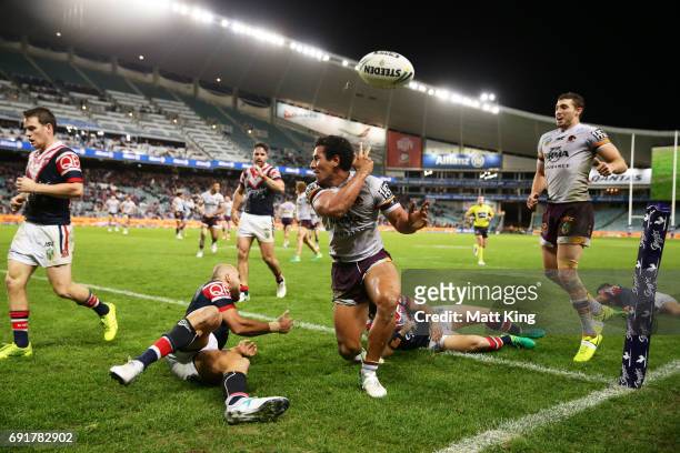 Tautau Moga of the Broncos celebrates scoring the final try during the round 13 NRL match between the Sydney Roosters and the Brisbane Broncos at...