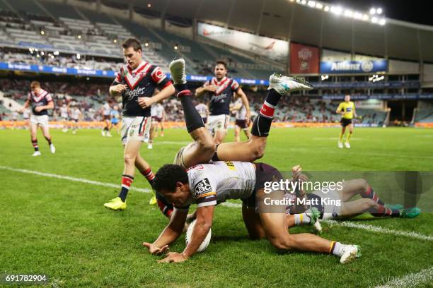Tautau Moga of the Broncos scores the final try as Blake Ferguson of the Roosters defends during the round 13 NRL match between the Sydney Roosters...