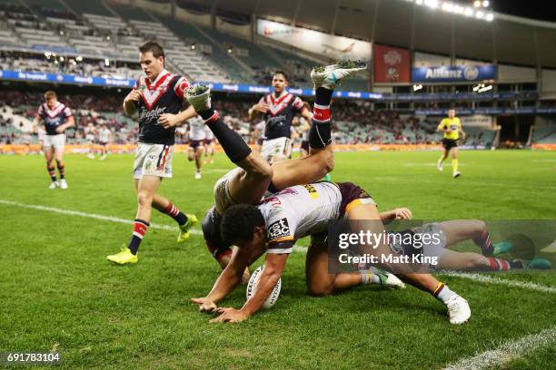 Tautau Moga of the Broncos scores the final try as Blake Ferguson of the Roosters defends during the round 13 NRL match between the Sydney Roosters...