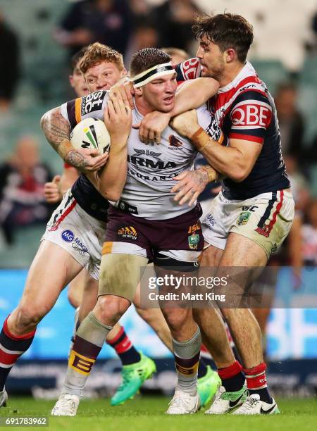 Josh McGuire of the Broncos is tackled during the round 13 NRL match between the Sydney Roosters and the Brisbane Broncos at Allianz Stadium on June...