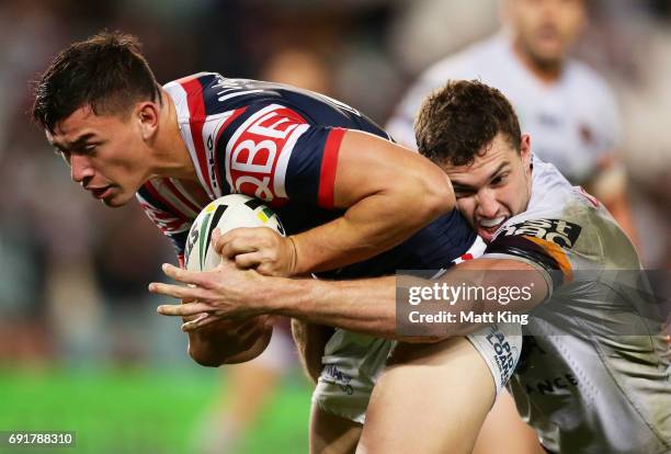 Joseph Manu of the Roosters is tackled during the round 13 NRL match between the Sydney Roosters and the Brisbane Broncos at Allianz Stadium on June...