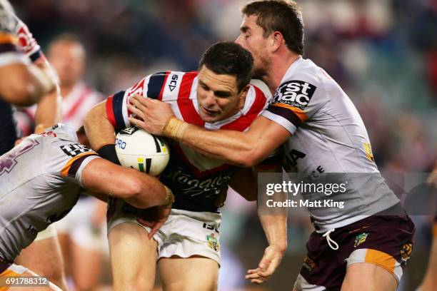 Michael Gordon of the Roosters is tackled during the round 13 NRL match between the Sydney Roosters and the Brisbane Broncos at Allianz Stadium on...