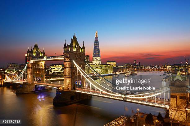 tower bridge and london skyline at sunset. - london landmarks stock pictures, royalty-free photos & images